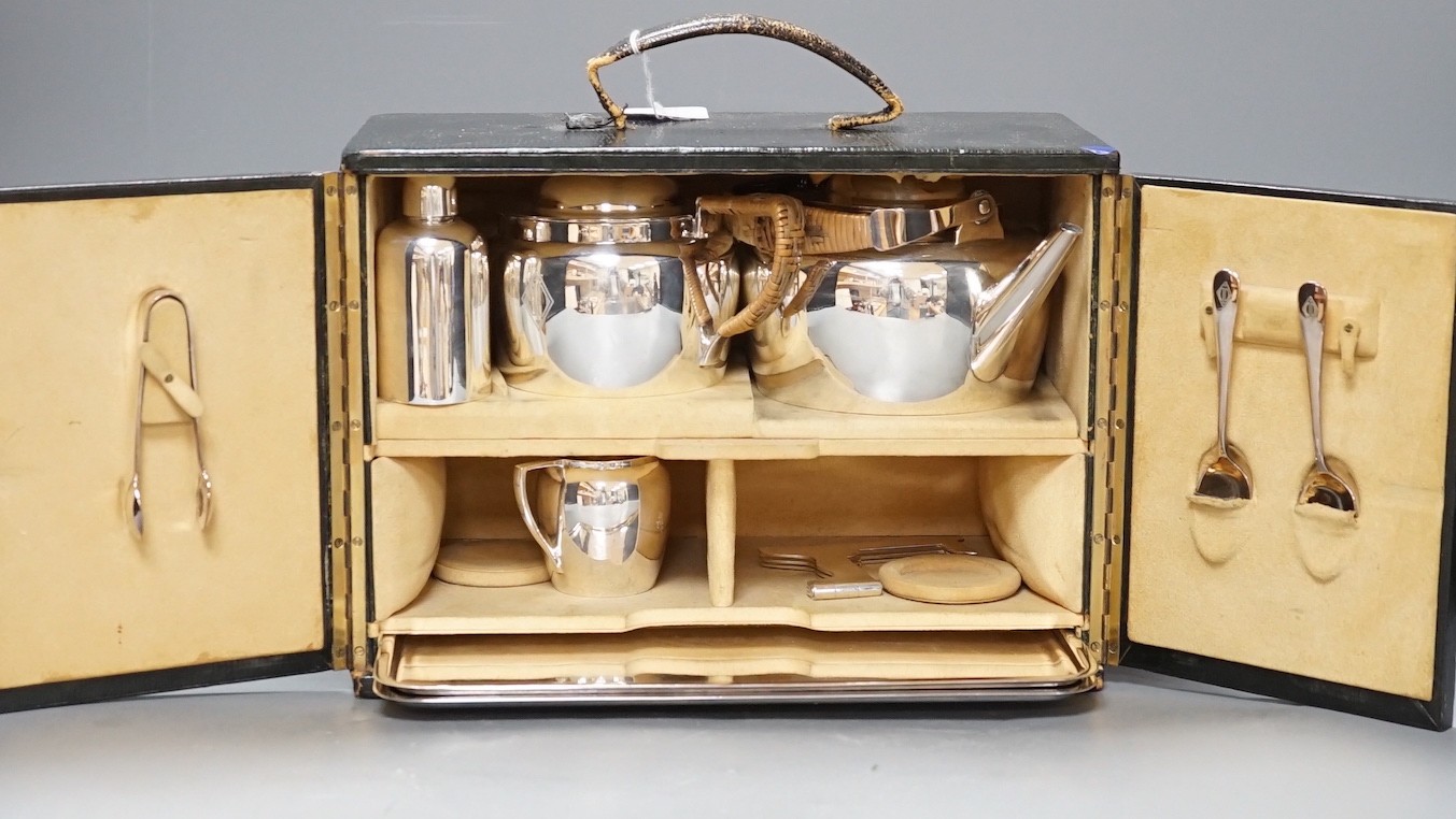 Christopher Dresser for Hukin and Heath, a silver plated travelling picnic / teaset, in suede lined green morocco case, case 21 cms x 29 cms